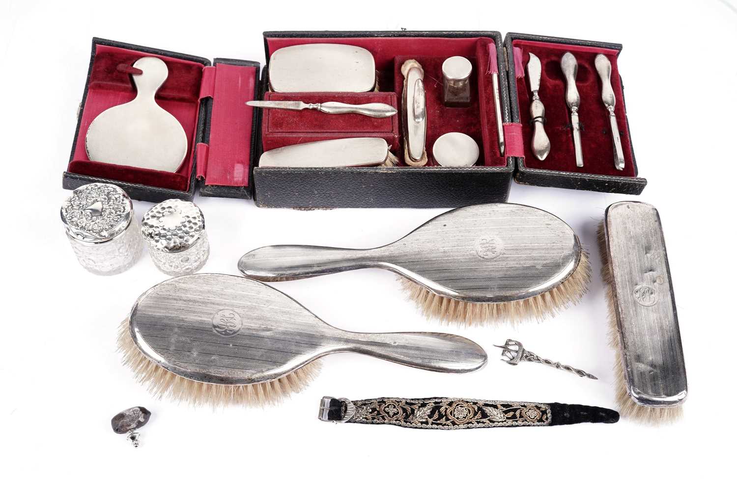 A cased George V travelling dressing set; and other dressing items