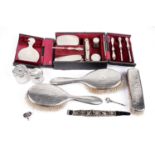 A cased George V travelling dressing set; and other dressing items