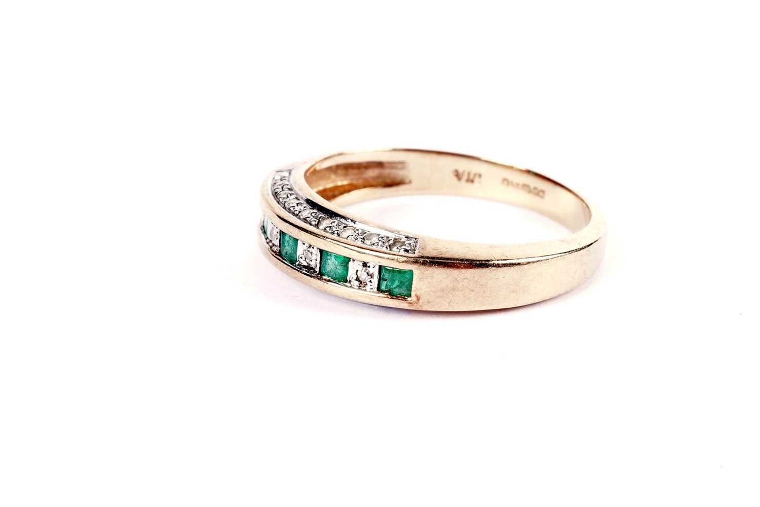 A diamond and emerald half hoop eternity ring