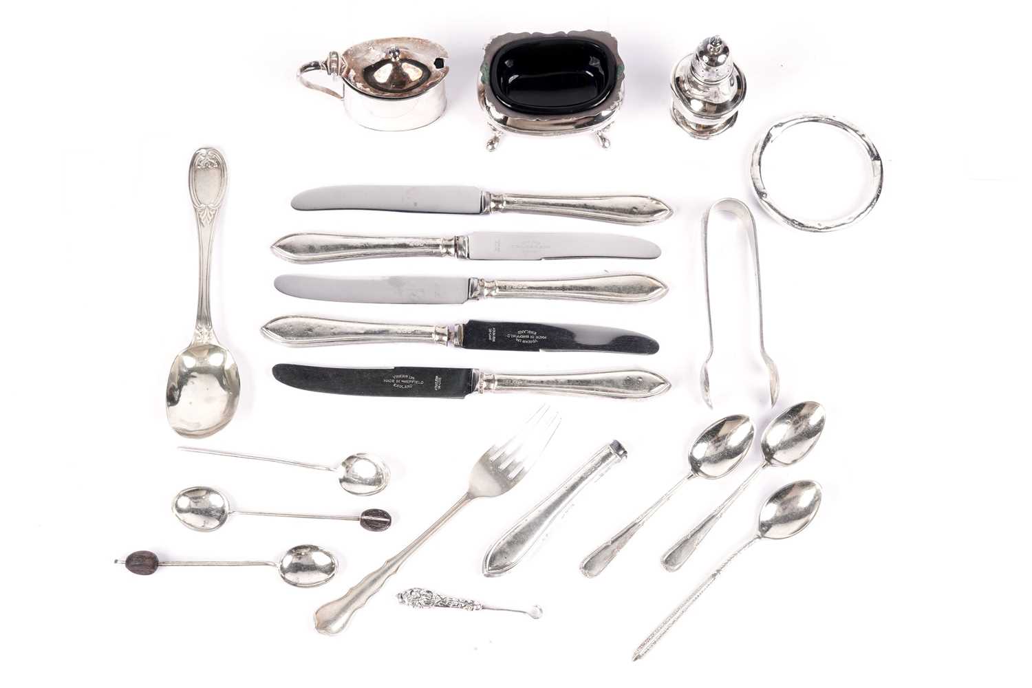 A selection of silver condiments, cutlery and collectibles