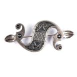 An Ola Gorie silver brooch modelled after a Celtic seahorse fibula