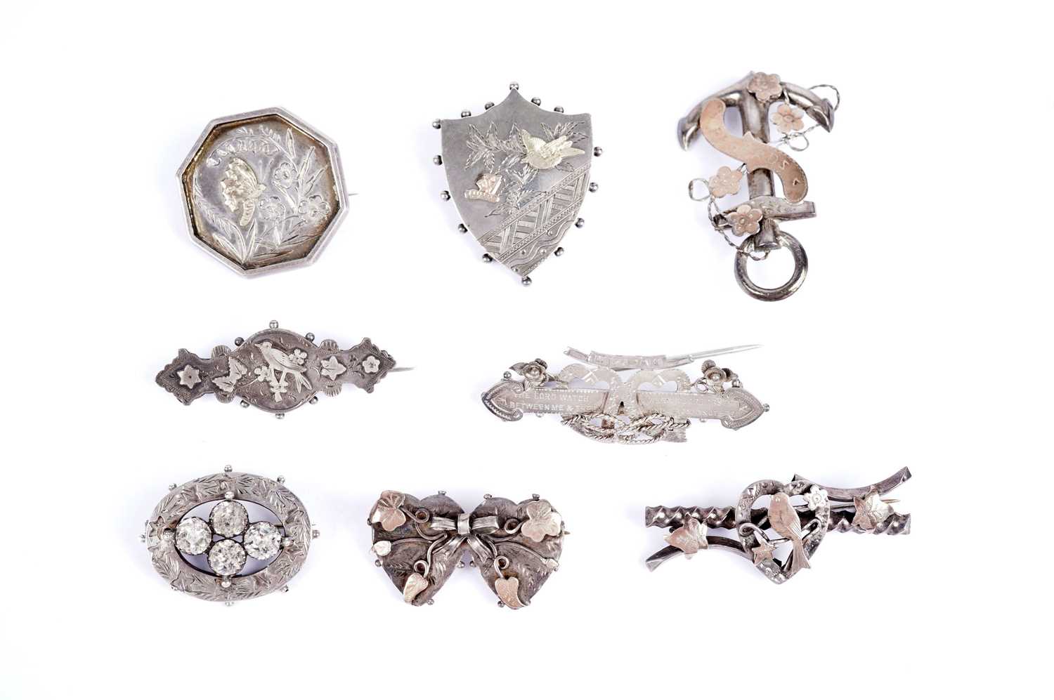 Late Victorian sentimental silver and white metal brooches