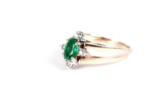 An emerald and diamond swivel ring
