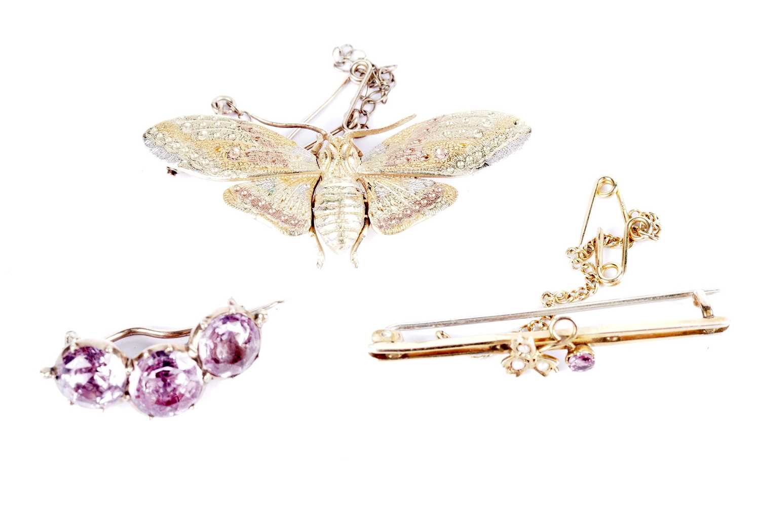 A yellow gold butterfly brooch; and two others