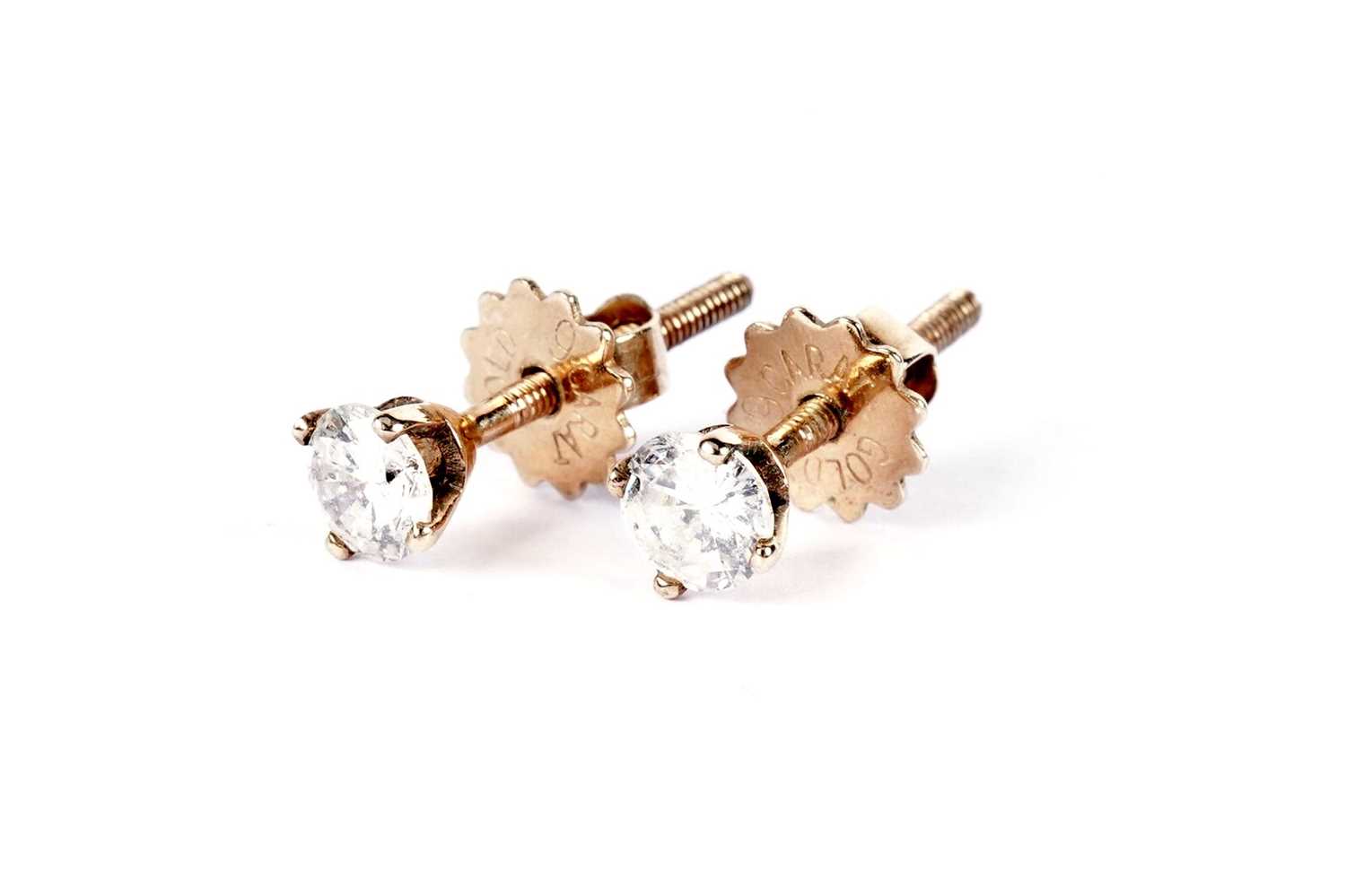 A pair of diamond stud earrings