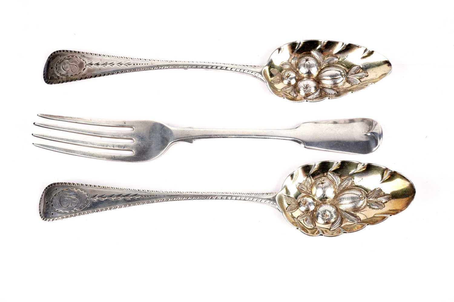 A pair of silver spoons and a silver table fork