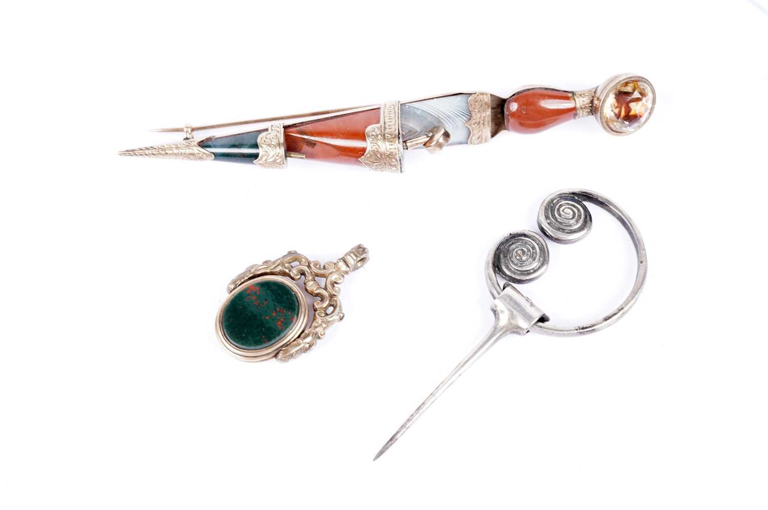 A Victorian plaid brooch; an Iona silver brooch by Alexander Ritchie; and a swivel fob