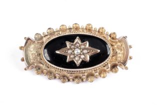 A Victorian seed pearl, black enamel and gilt metal mourning brooch