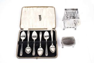 A set of six George V silver teaspoons; a silver salt cellar; and a silver reticulated pot