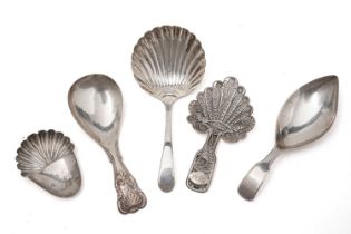 A selection of silver caddy spoons and a caddy spoon bowl