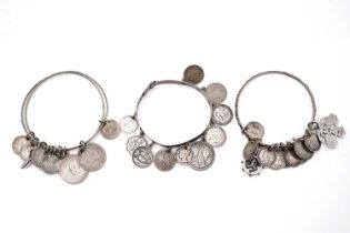 Three silver-coin love token charm bangles