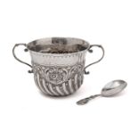 A silver porringer, by Josiah Williams & Co and a caddy spoon