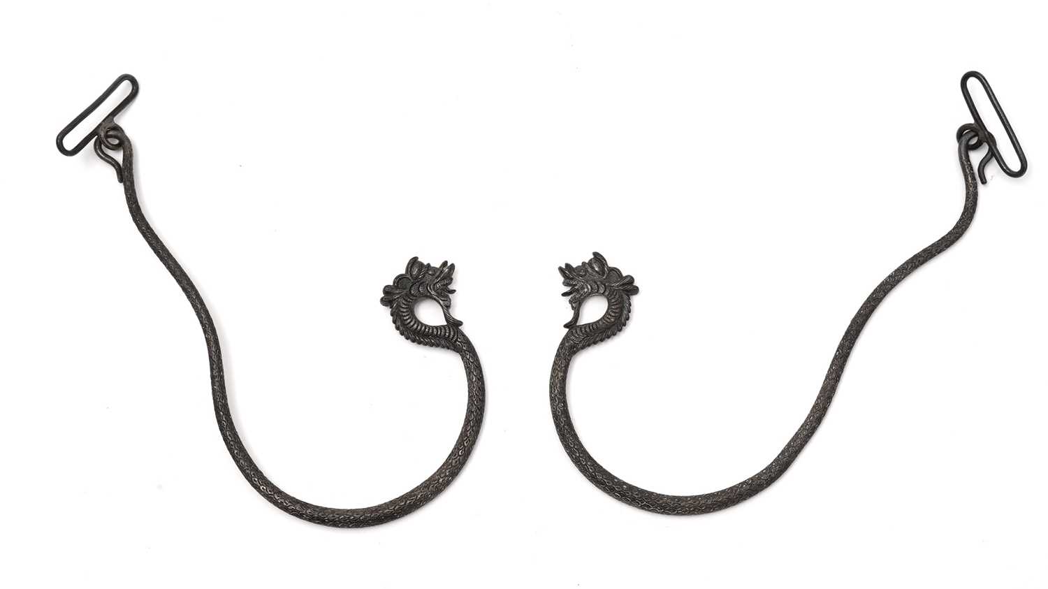 A pair of eastern silver decorative hooks