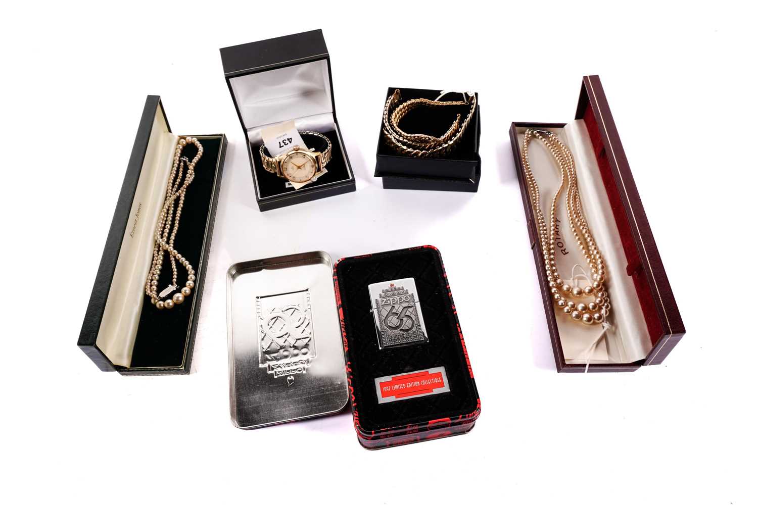 A Smiths wristwatch; a Zippo lighter; and three necklaces