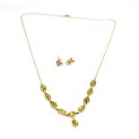A peridot and yellow gold necklace and earrings