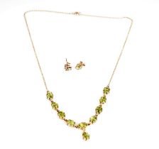 A peridot and yellow gold necklace and earrings