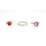 A fire opal and diamond ring; and two others