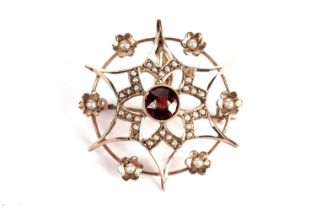 An Edwardian garnet and seed pearl flower pendant brooch