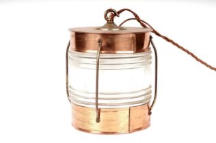 A copper and brass ships lantern, converted into a ceiling or hanging light