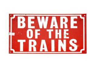 A Beware of the Trains enamel danger sign