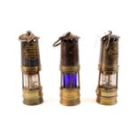 Three miners safety lamps