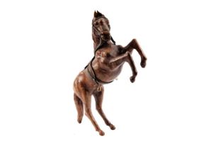 A vintage leather figure of a rearing horse
