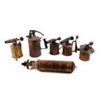 A selection of brass blow torches and a fire extinguisher