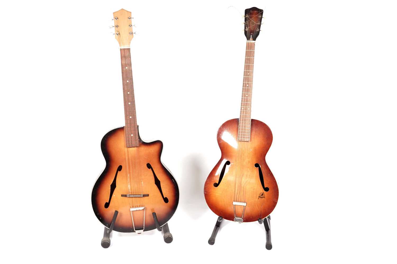 Two 6-string acoustic cello-bodied guitars