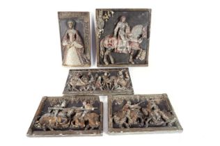 A set of cast plaster wall plaques depicting medieval scenes