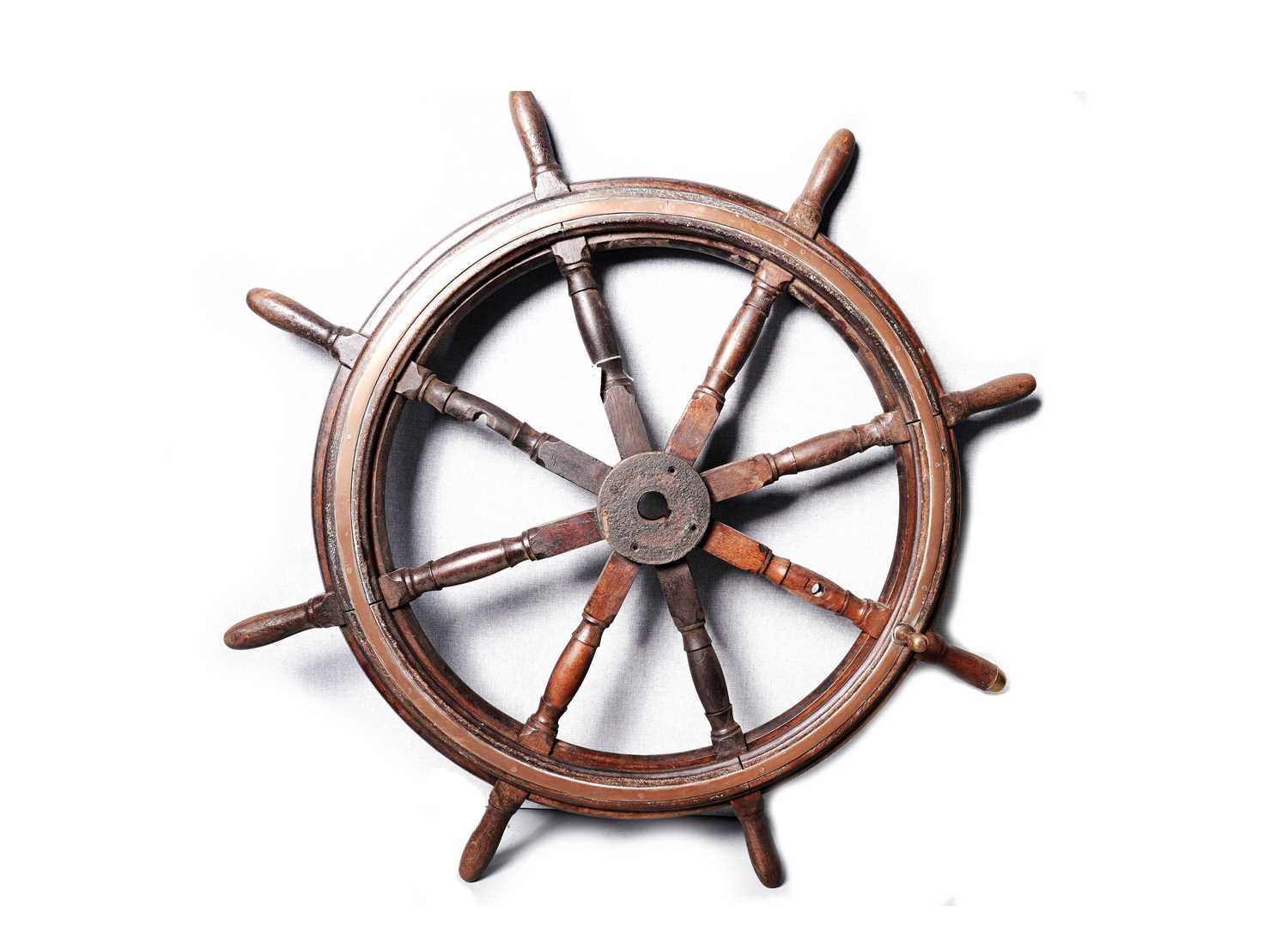 A stained oak ships wheel