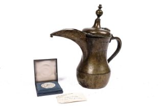 A bronze Islamic dallah coffee pot, given as a gift by the Crown Prince of Jordan 1992