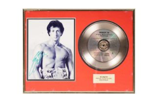 A Rocky IV 'gold' disc and signed Sylvester Stallone photograph