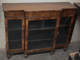 A 19th century rosewood breakfront bookcase with glazed doors on short turned supports, decorative