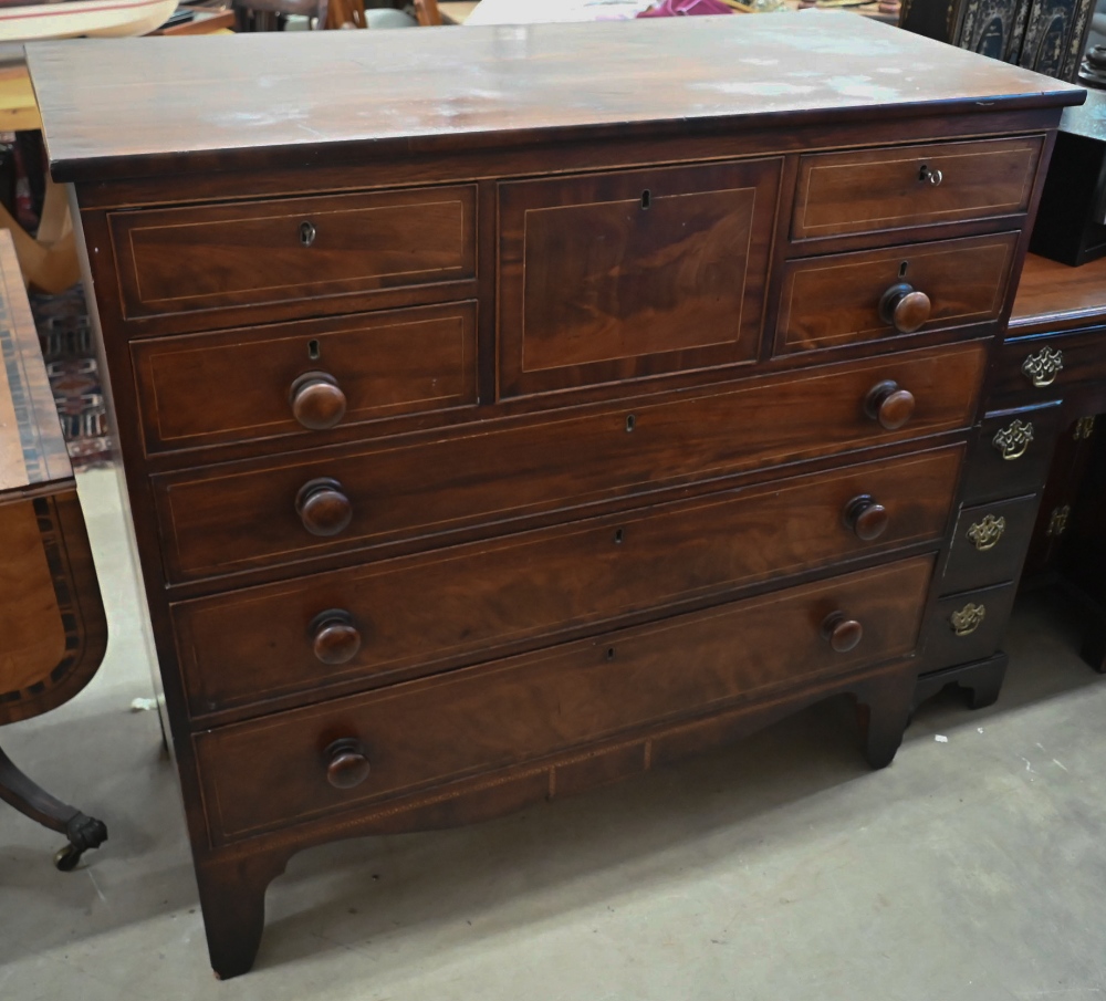 A large Victorian millinery chest with arrangement of eight drawers raised on shaped bracket feet,