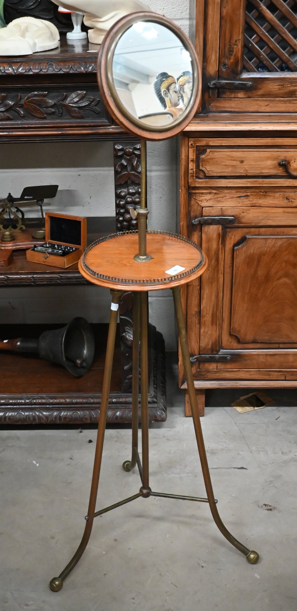 An antique mahogany and brass shaving/vanity stand with height adjustable circular mirror, makers