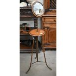 An antique mahogany and brass shaving/vanity stand with height adjustable circular mirror, makers