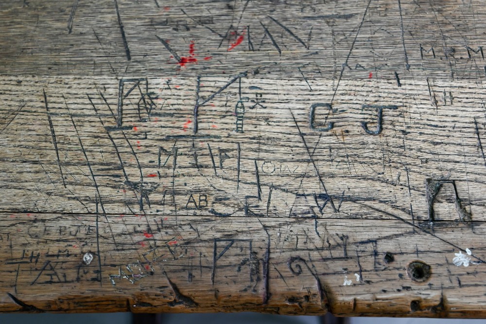 A Victorian cast iron and oak student/school desk, the slope top carved with multiple graffiti, - Image 5 of 7