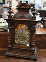 A German stained wood mantel clock, striking on two coiled gongs, 48 cm high