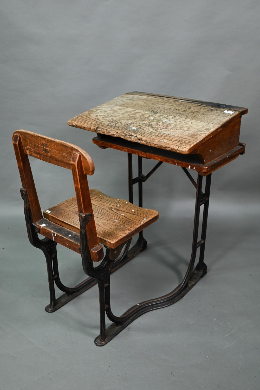 A Victorian cast iron and oak student/school desk, the slope top carved with multiple graffiti, - Image 3 of 6