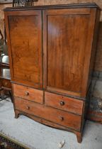 A 19th century mahogany linen press, the top with panelled doors enclosing five slides on three