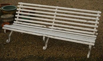 A classic wood-slat garden bench on three wrought steel mounts, painted white, 183 cm long