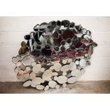 A modern abstract 'pebble' design mirror, 127 cm wide x 114 cm high