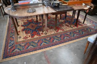 An Egyptian made 'Arabella' carpet, red and blue geometric design on camel ground, 330 x 240 cm