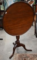 A 19th century mahogany circular tilt-top occasional table on turned column and triform supports, 62