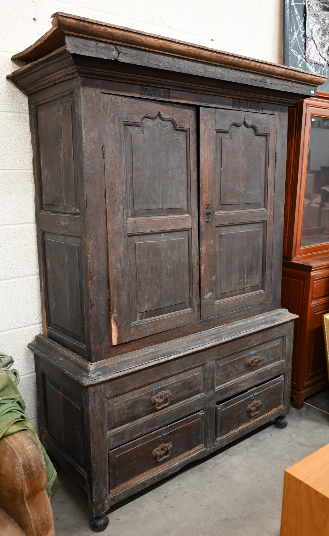 An 18th century and later oak livery cupboard with panelled doors on base with two drawers below
