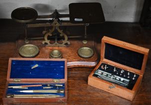 An antique brass set of postage scales with weights on oak base, to/w a boxed set of precision