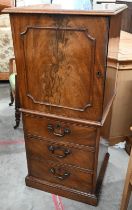 A 19th century mahogany drinks cabinet with panelled door over three drawers, 52 cm wide x 45 cm