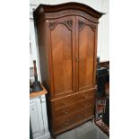 A mahogany arch-top combination wardrobe, the panelled doors enclosing pull-out hangers on chest