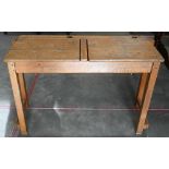 A vintage beech double school desk with twin-hinged panelled top, 108 cm wide x 40 cm deep x 66 cm