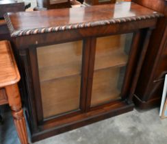 A Victorian mahogany bookcase with glazed doors between turned columns, raised on plinth base, 104